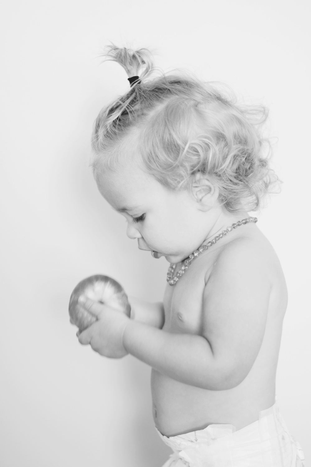 rocco eating an apple, wearing a manbun, being photographed by his sister